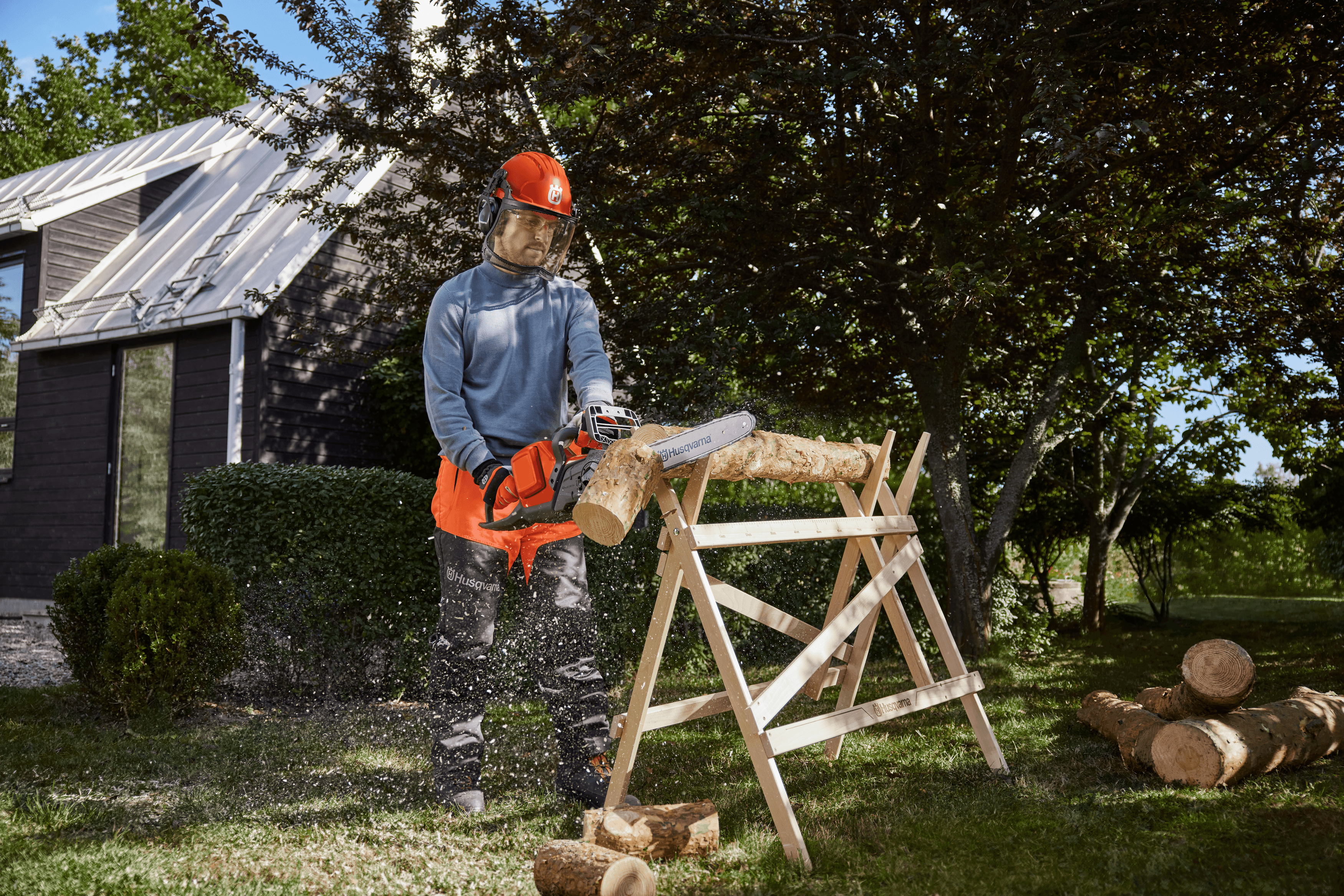 man holding chainsaw whilst cutting tree